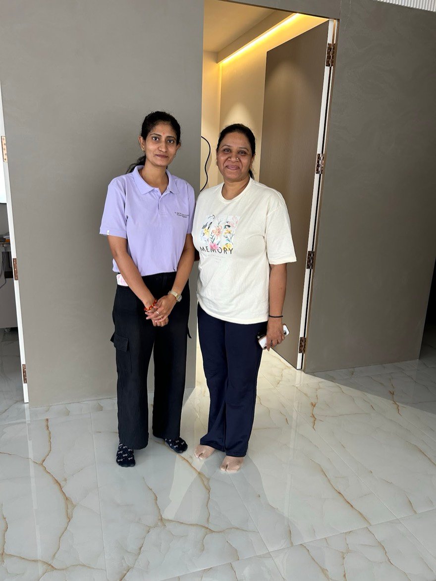 A senior physiotherapist with a patient at Trivayu Physio Center